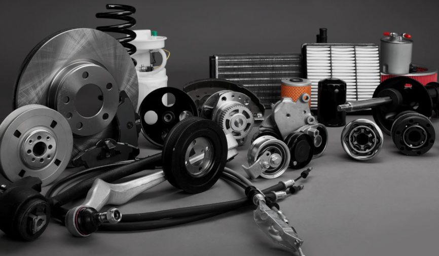 New car parts on a gray background closeup. Shop for auto. The composition of the new auto parts